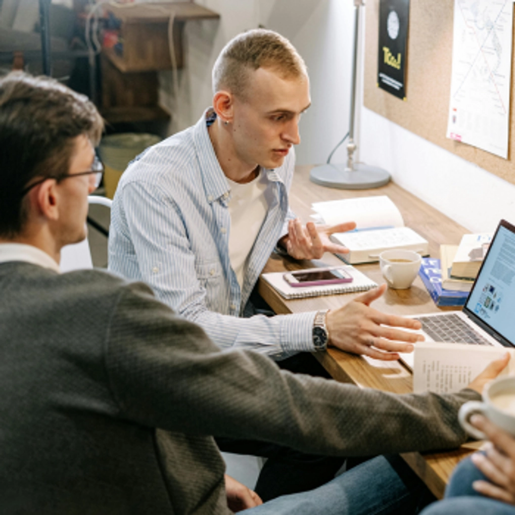 students looking at a laptop with Trinity Employability Bursary on screen