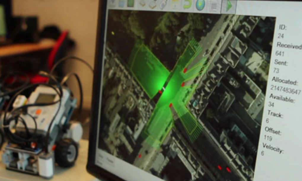 An image of a screen and an autonomous vehicle