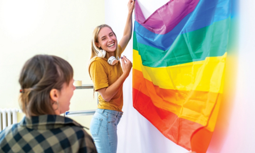 Young people hold rainbow flag