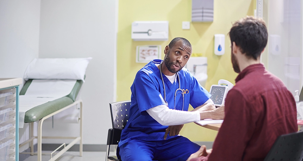 Doctor talking to patient in surgery room