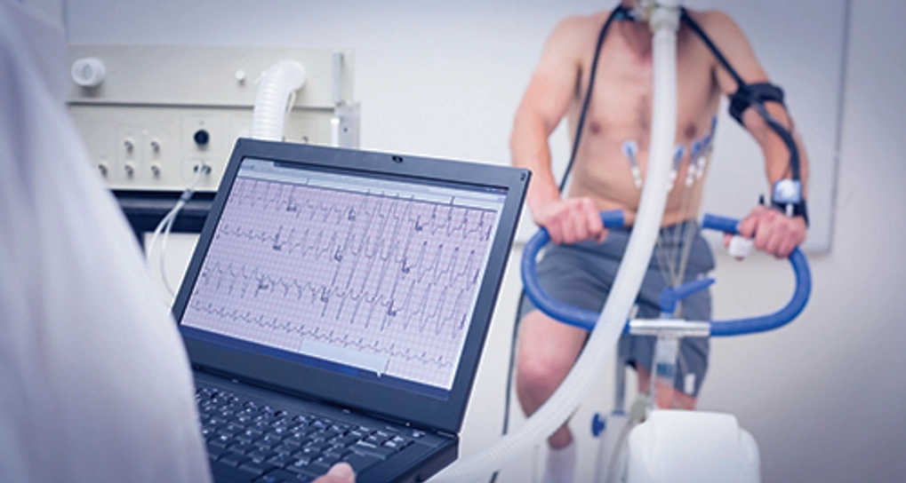 Man on an exercise machine being tested in a lab