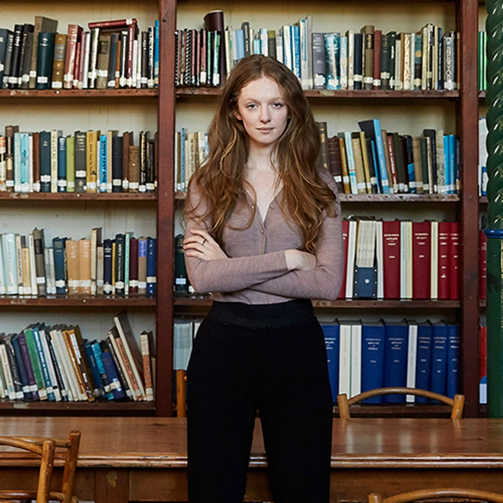 Woman standing in front of books