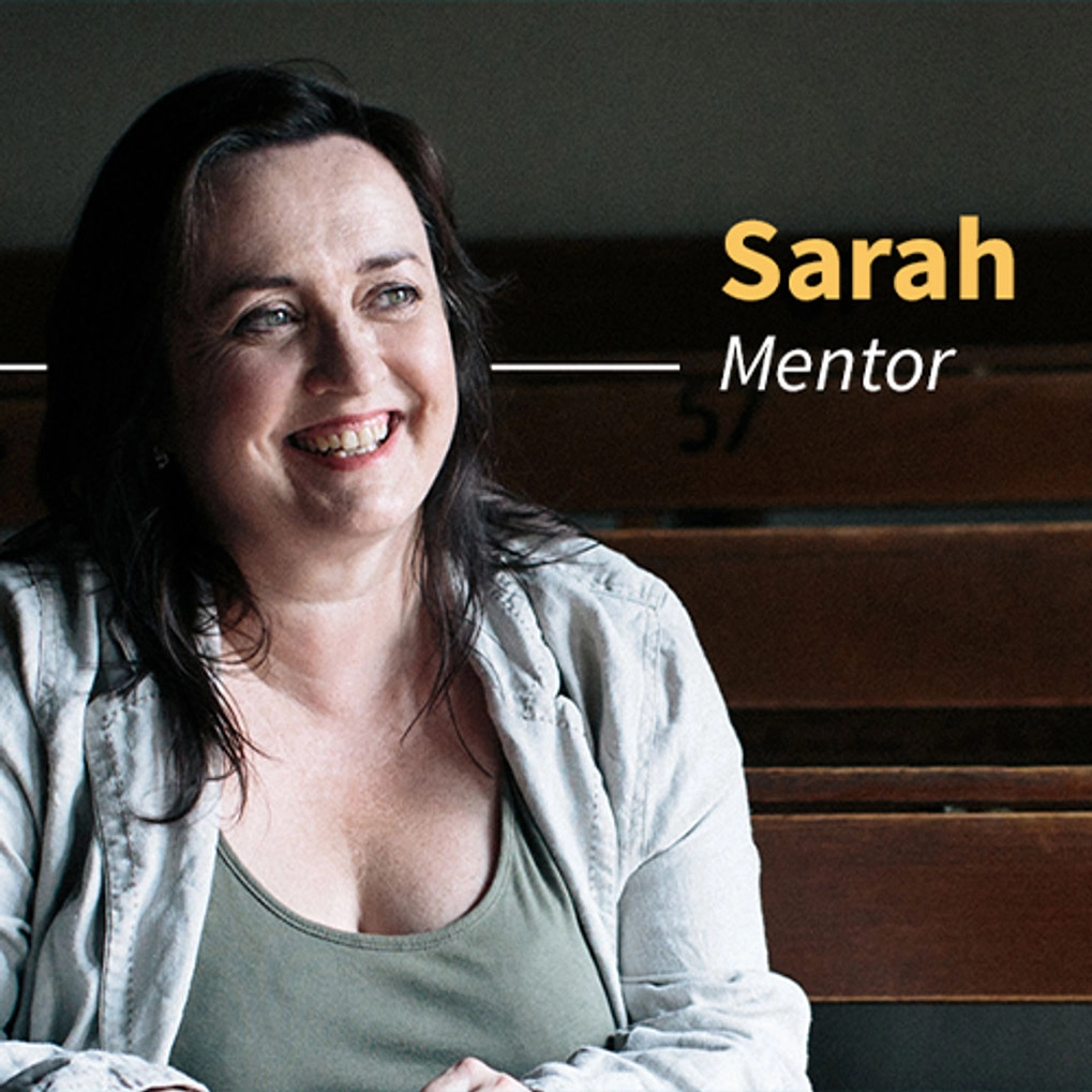 A Woman sitting at a row of desks
