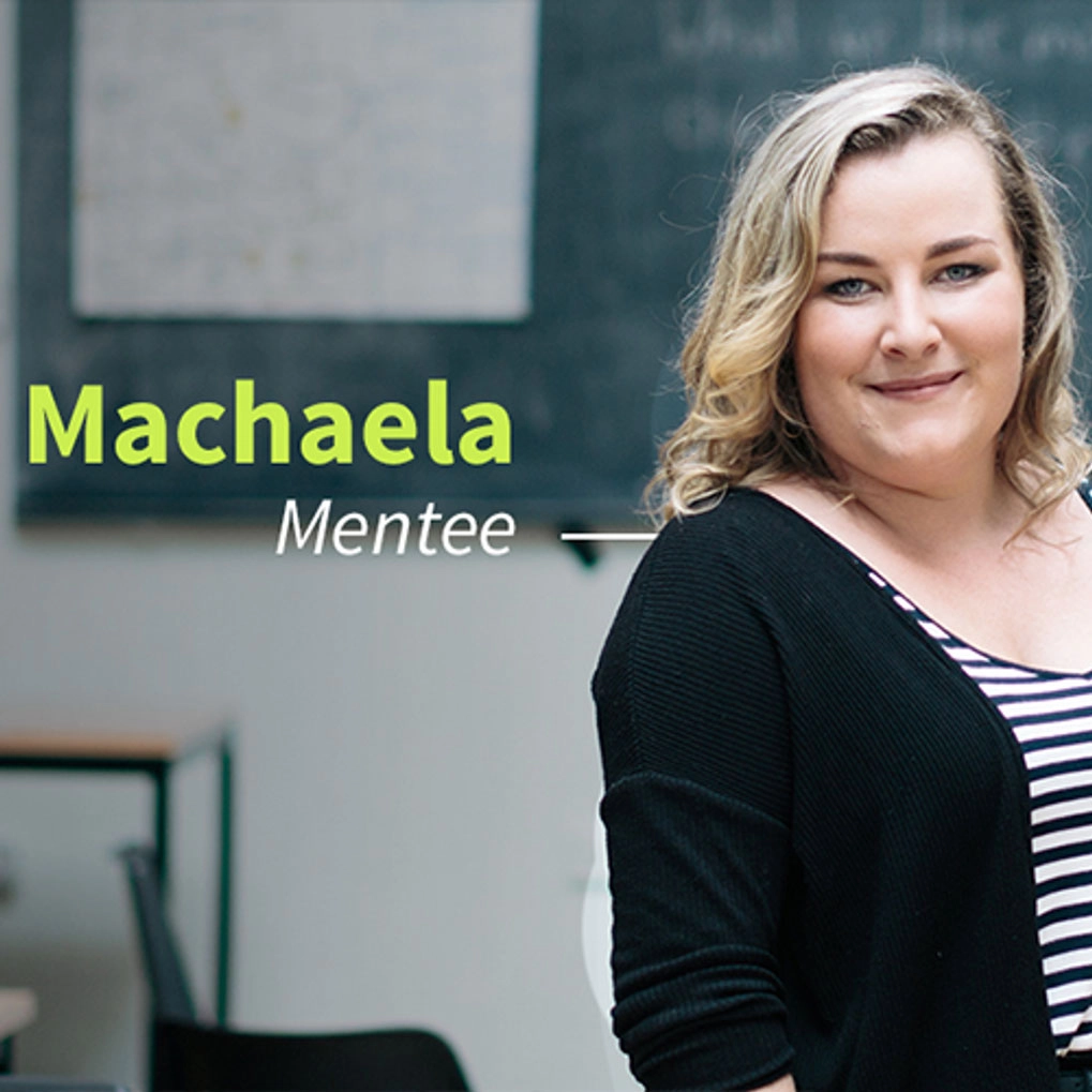A woman standing in front of a blackboard