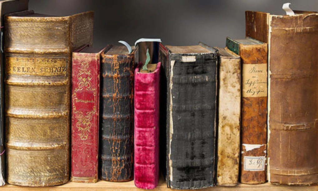 set of old books sitting on a shelf