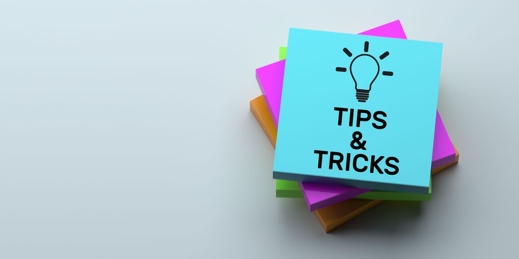 A white background with a stack on post it notes with the text Tips & Tricks written on top