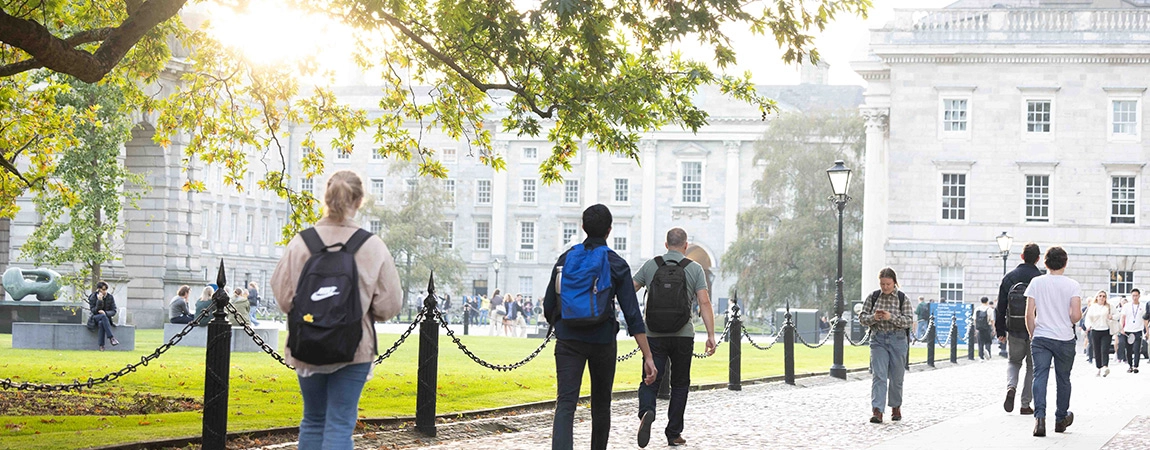 people walking across front square