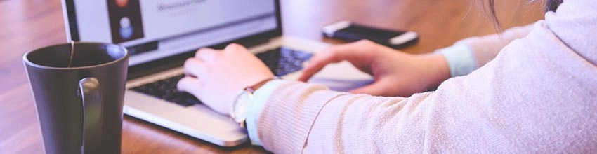 hands typing on laptop