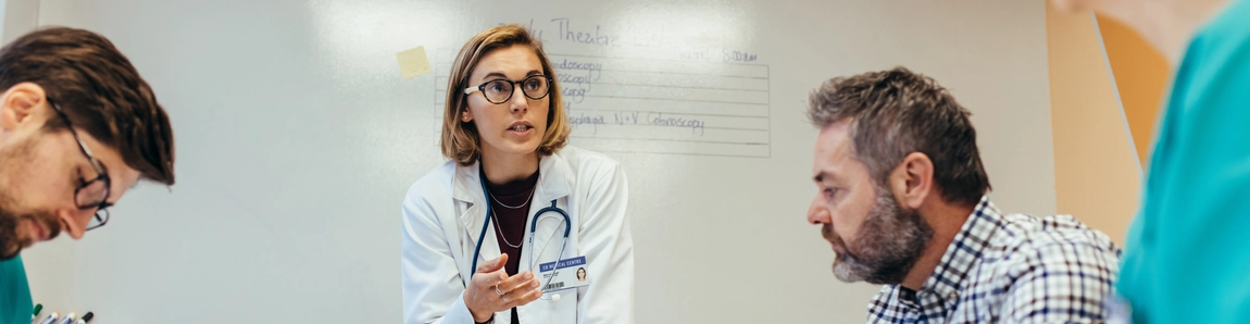 Medical team and business professional in meeting