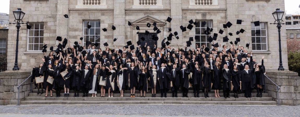 Graduates throwing their caps up in the air