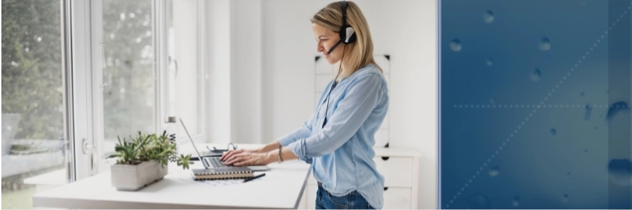 Woman working on her laptop at a standing computer bench