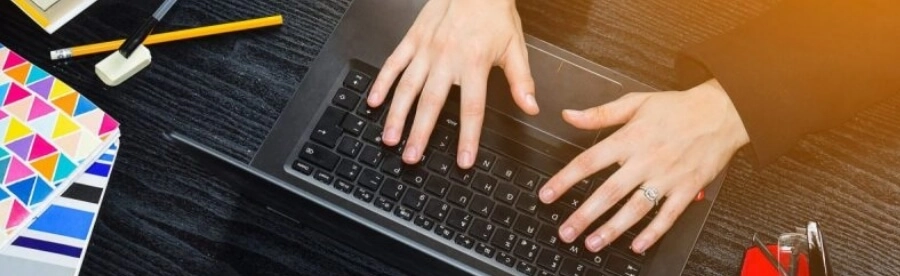 NCBI person typing on a keyboard