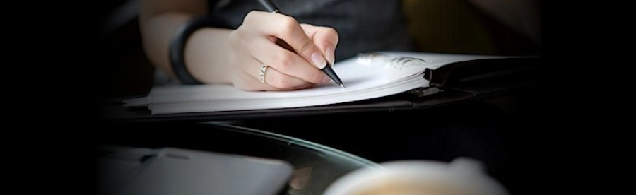 A person writing in a book