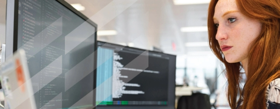 A student looking at two computer screens