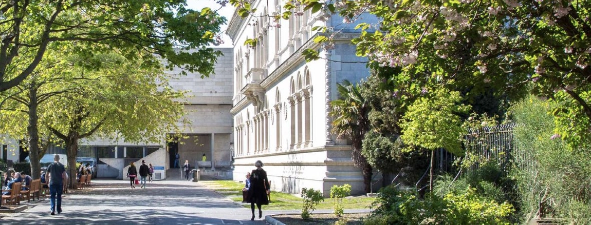 A person walking through Trinity Campus