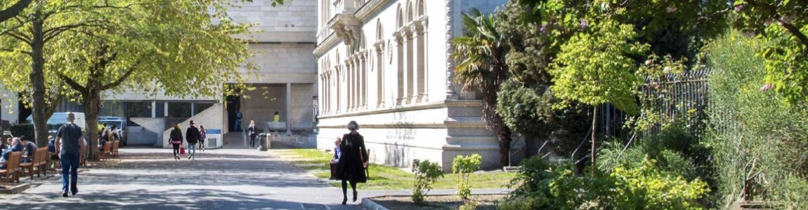 A student walking towards the library in Trinity College Dublin