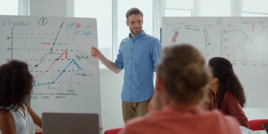 A person standing in front of a whiteboard