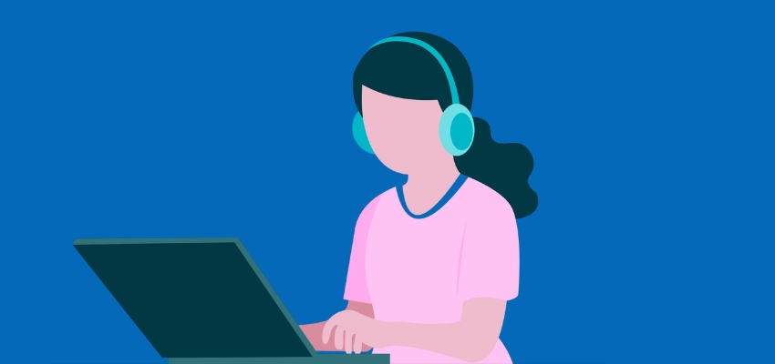 image of student sitting at computer with headphones on