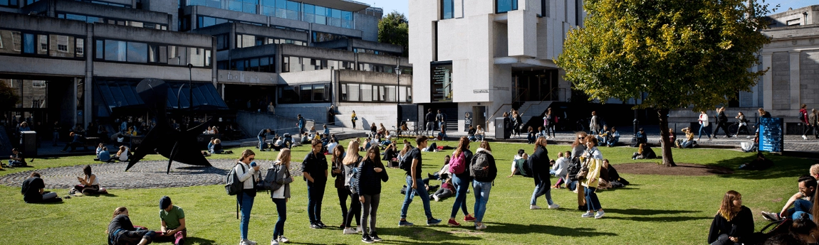 Students walking on Fellow's Square in front of the Arts Building.