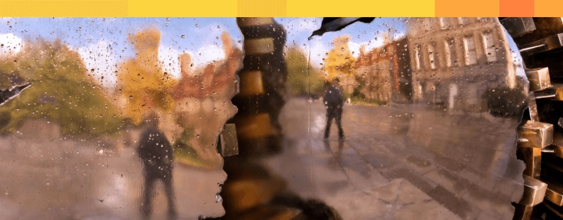 A person reflected in the Pomodoro sphere