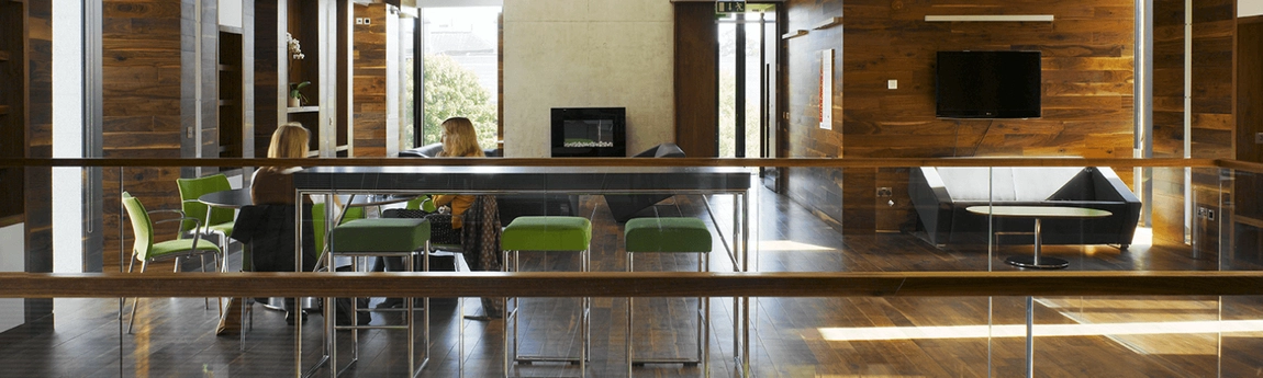 Two people having a conversation in the Long Room Hub