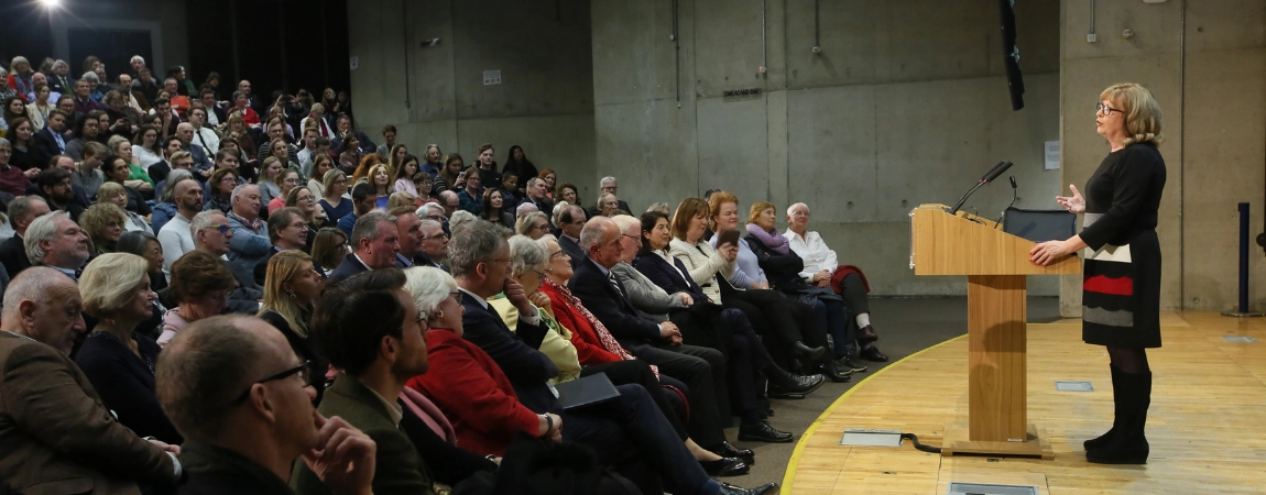 Speaker standing at podium in front of audience