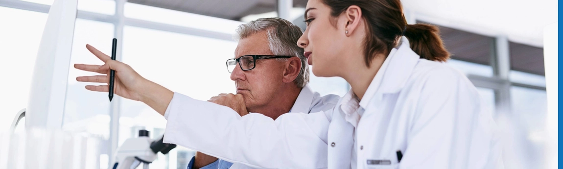 Two pharmacists discussing something they can see on a screen
