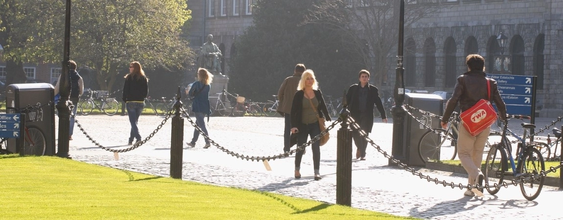 Students walking on the grounds of Trinity College Dublin.