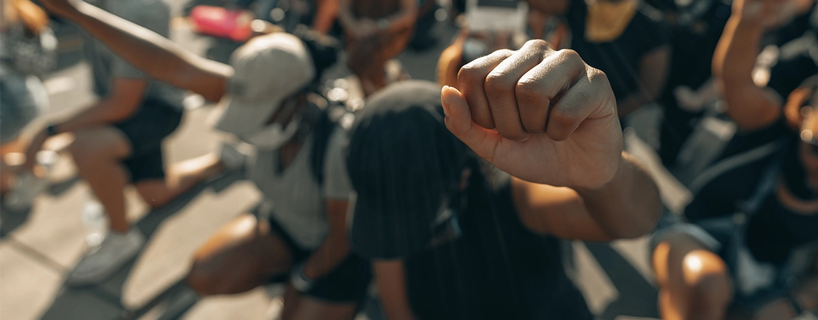 Figure in crowd holding up curled fist