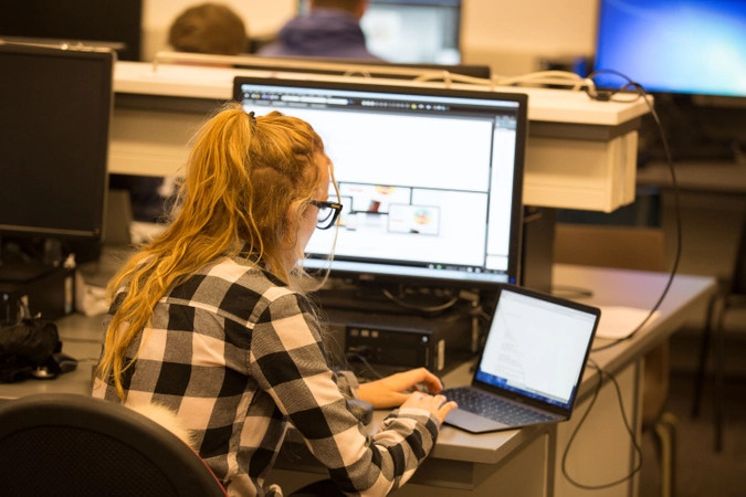A person working on a computer in the computer lab