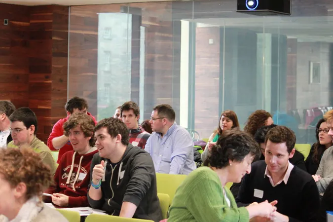 Photo from the first Peer mentoring SIG meeting in 2012 showing students and staff in discussion.