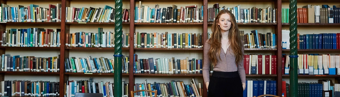 Woman standing in front of books