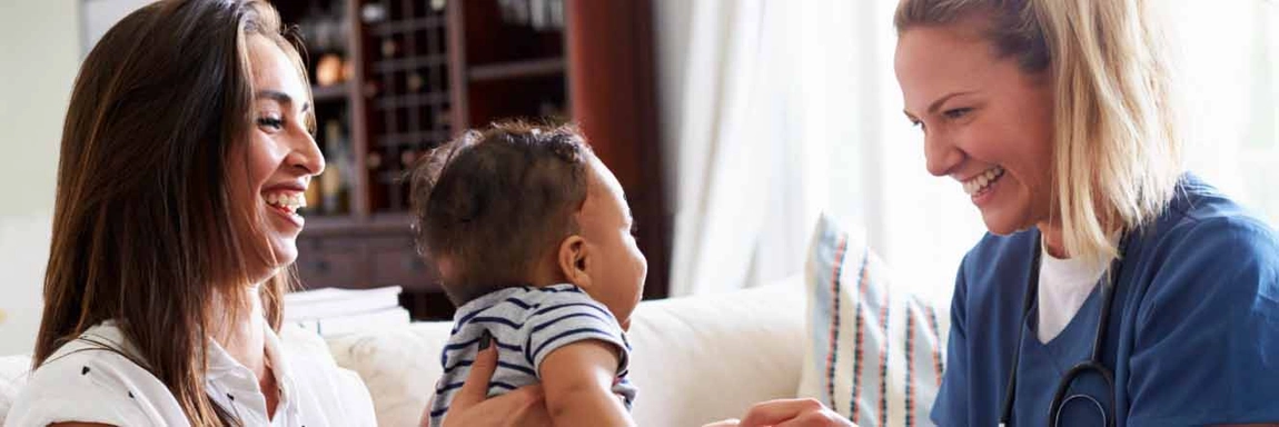 Mother holding baby at doctor visit