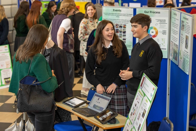 Students beside a poster