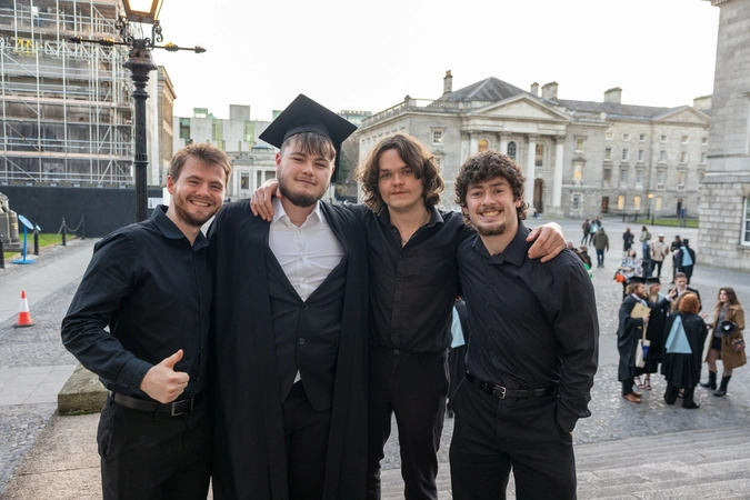 Young men celebrate at college graduation