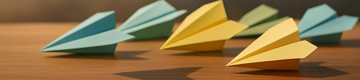 Six paper airplanes on a desk