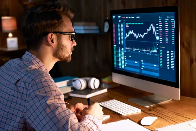 Man looking at data on a desktop computer