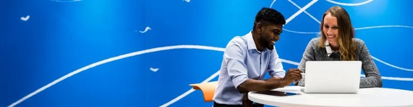 A men and a woman working together at a desk