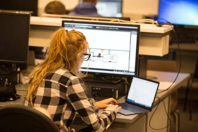 A person working on a computer in the computer lab