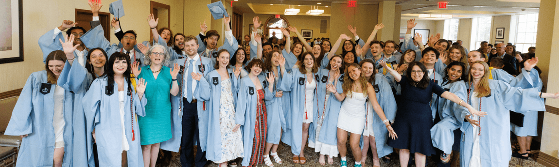 A group of Dual BA students wearing graduation robes.