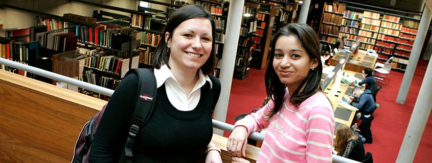 Two students in the library at Trinity