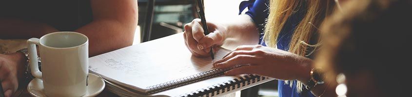 A close up photo of someone writing on a refill pad