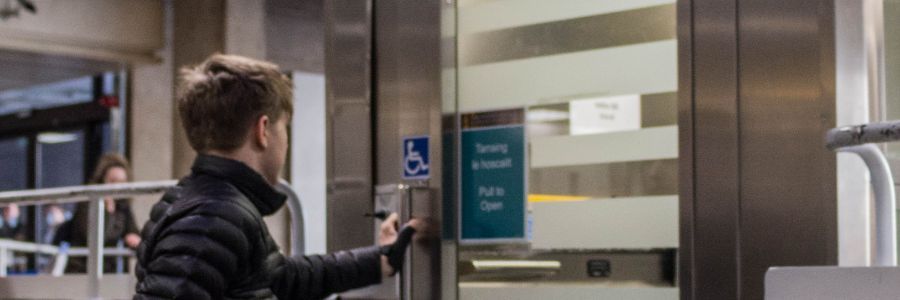 A young wheelchair user accessing an accessible lift at Trinity College Dublin