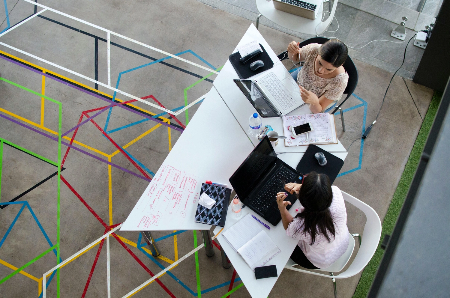 Colleagues working on computers against brightly coloured background