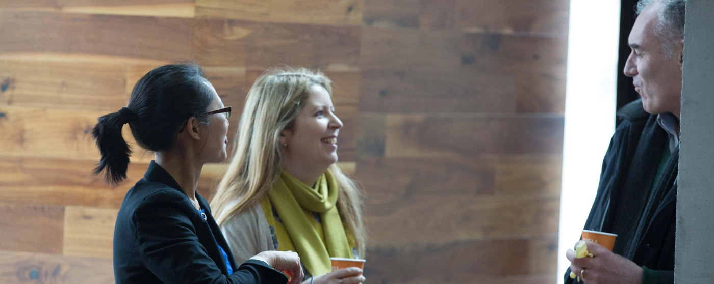 three people chatting while enjoying a coffee