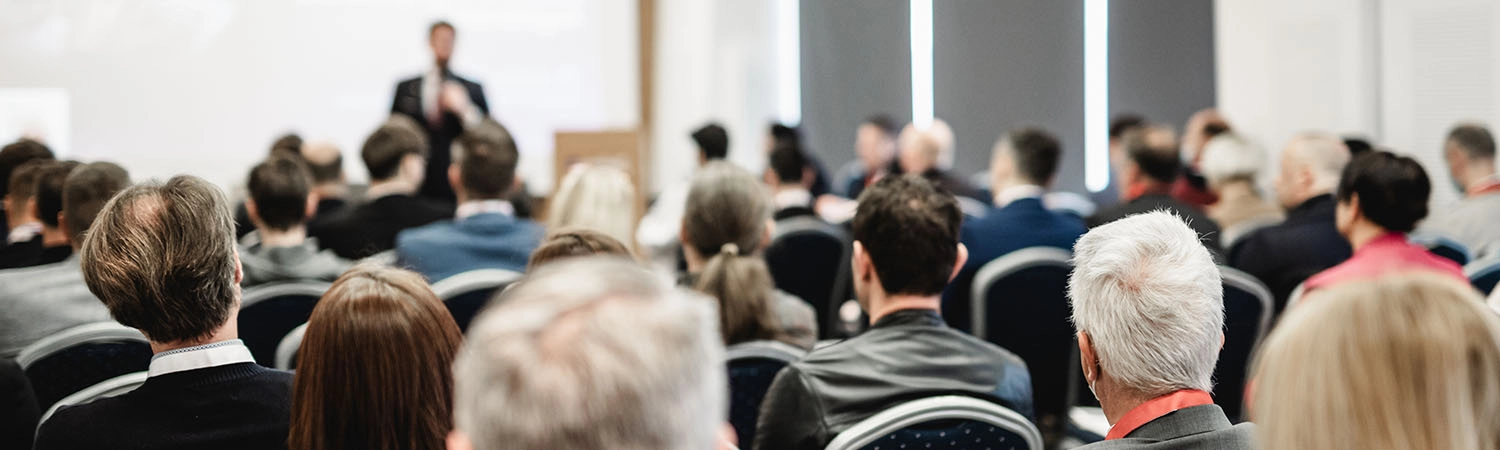 Speaker at a conference with audience