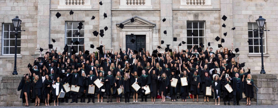 Students throw graduation caps in the air