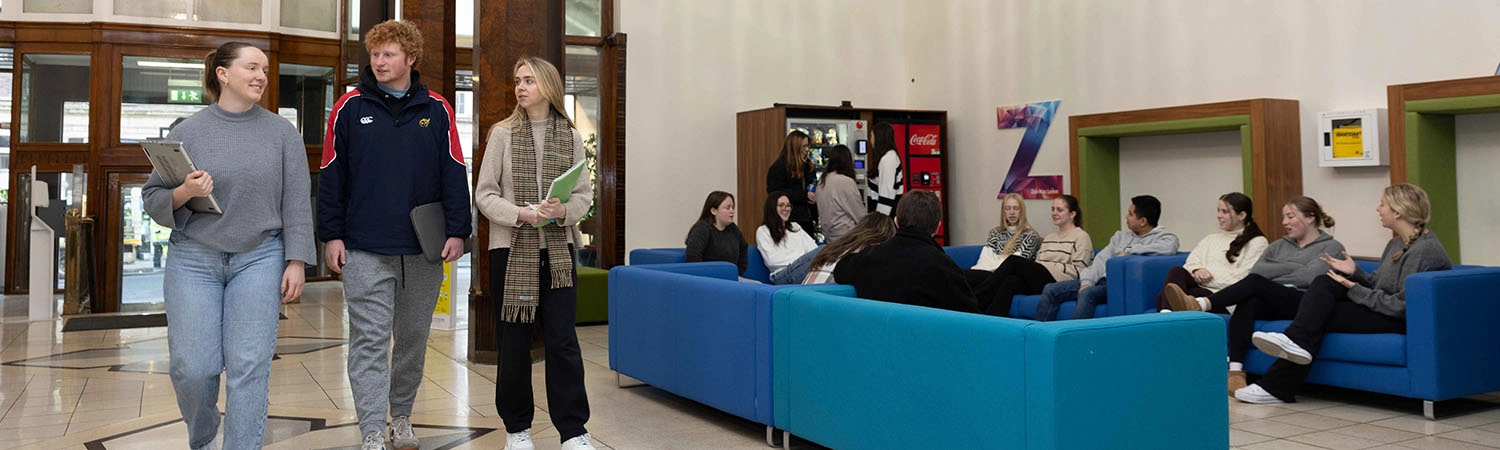Students in the School of Nursing and Midwifery walking through the foyer