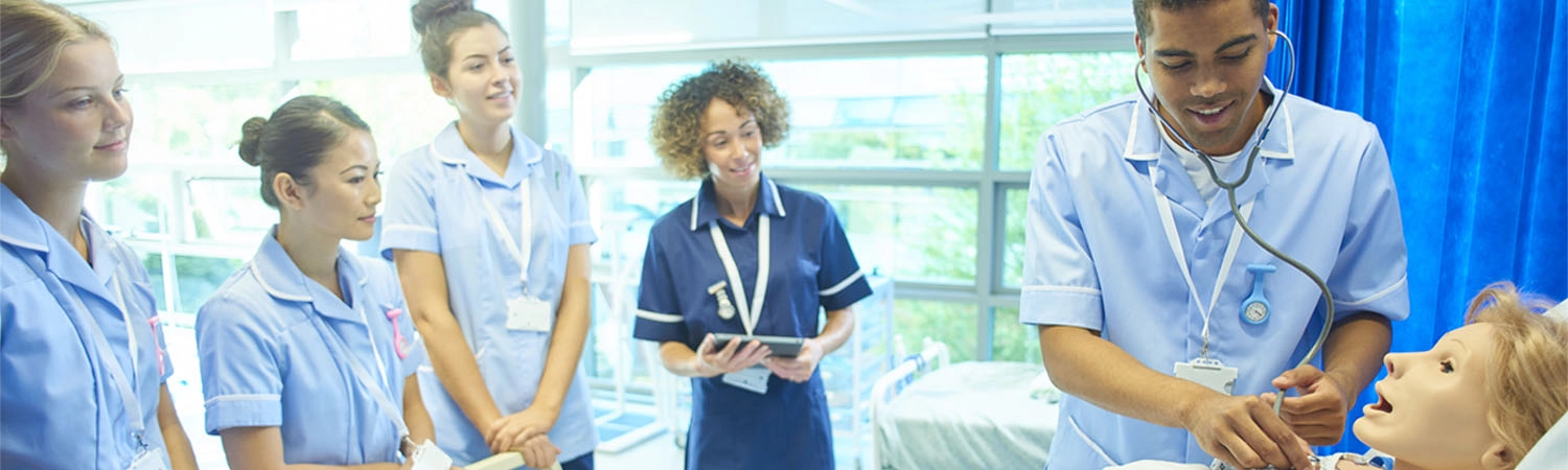 medical students on the ward with a medical mannequin in a bed