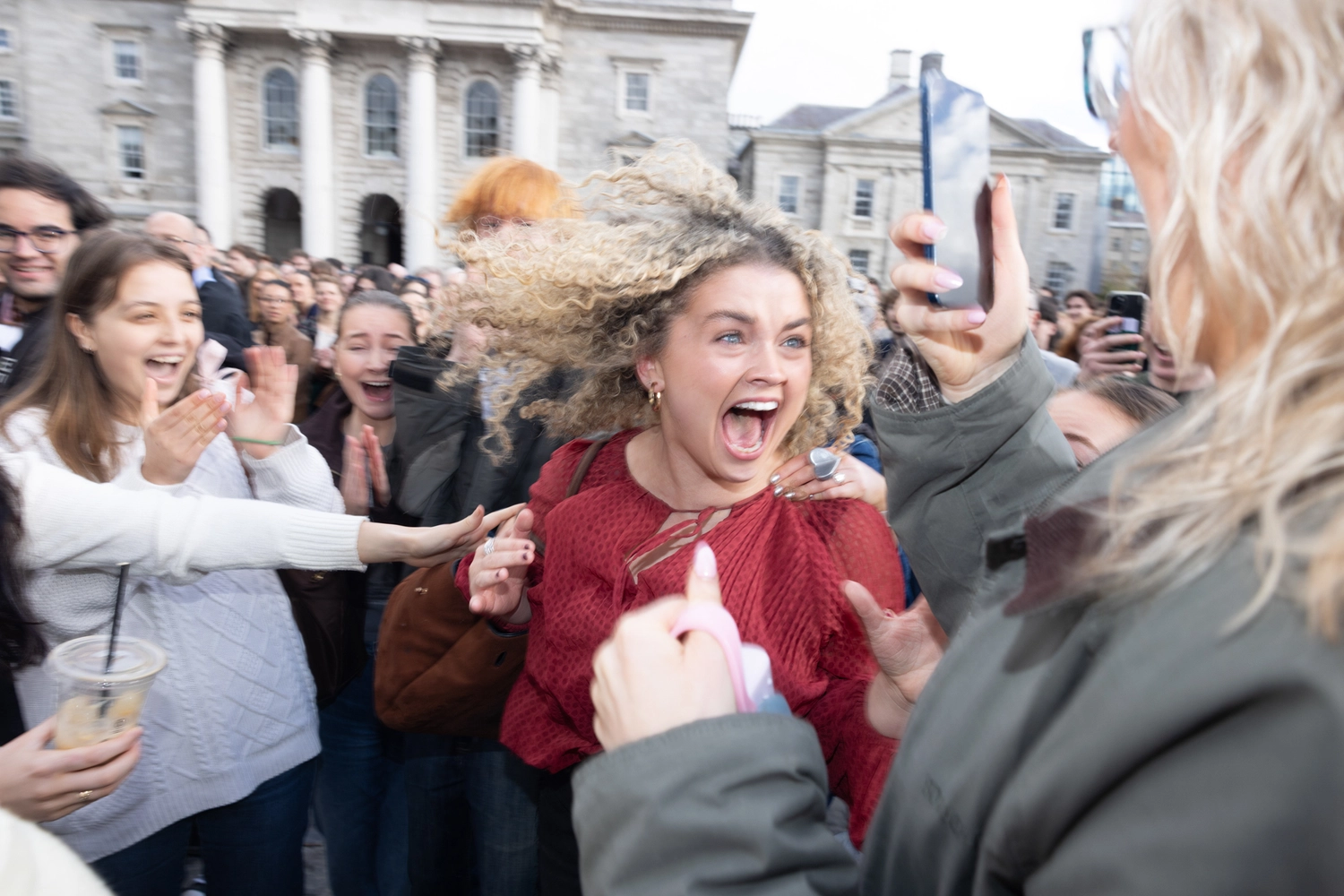 A Scholar celebrating on Front Square after hearing their name announced on Trinity Monday.